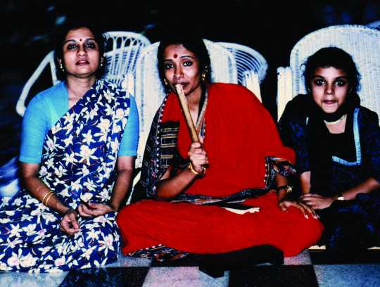 Seated group photograph of Ranee Ramaswamy, Alarmél Valli, and Aparna Ramaswamy