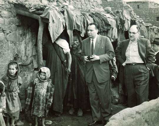 Black and white photograph of the executive director of the United Jewish Federation Council of St. Paul and the executive director of the Jewish Federation Council of Kansas City visit a home in Ourika, Morocco during a tour of conditions of Jews in North Africa, undated. 