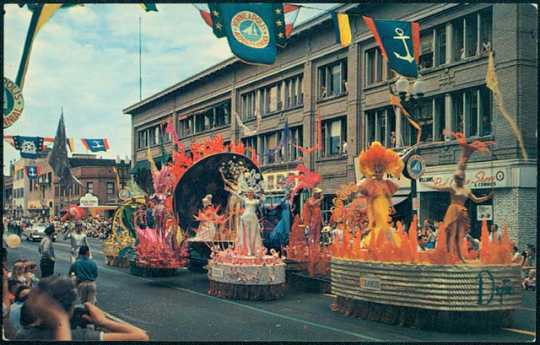 Parade floats passing down a Minneapolis Street for Aquatennial's Grande Day Parade, 1960.