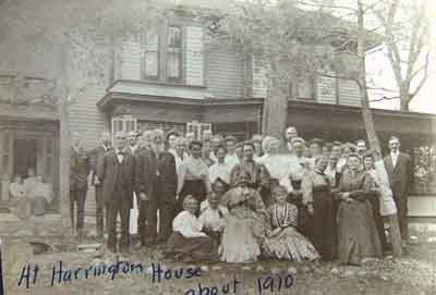 Black and white photograph of a group of people at the Harrington-Merrill House, c.1910.