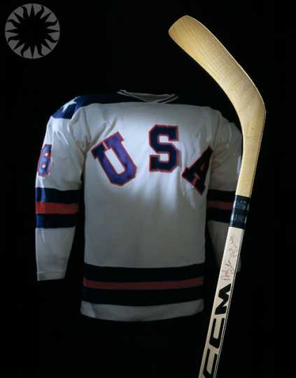 Color image of Bill Baker’s 1980 Olympic jersey and hockey stick. Photographed on November 3, 2004, and shared via Flickr by public.resource.org.