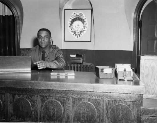 St. Paul Police Deputy James S. Griffin sitting at his desk, ca. 1960s. From box 1 of the James S. Griffin papers (P1679), Manuscripts Collection, Minnesota Historical Society.