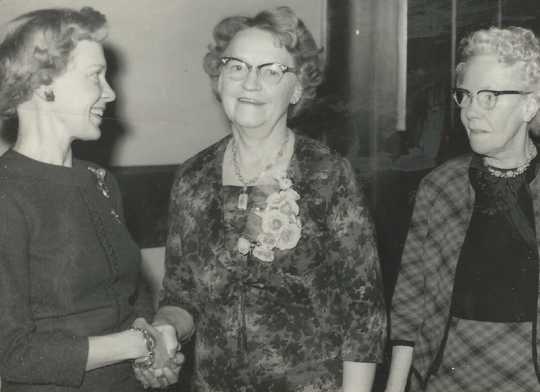 Black and white photograph of Mary Vattendahl, left, presents the 1966 Woman of Achievement award to Clara Berg (center) as Bergetta Logen, a long-time Crookston resident and the BPWC’s fourth president (right) looks on, 1966.