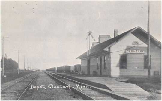 Black and white postcard showing the Great Northern Railway Depot and a grain elevator behind the depot in Clontarf, c.1880s.