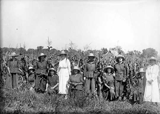 Incarcerated women posing by a cornfield