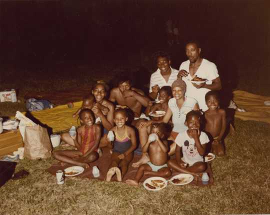 Color image of children and adults during a picnic. Photograph by Charles Chamblis, ca. 1985.