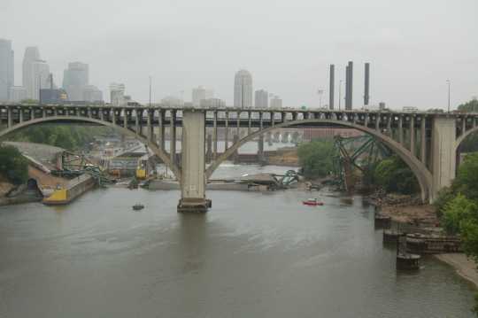 View of the I-35W bridge wreckage in the Mississippi looking through the arches of the  Tenth Avenue bridge in Minneapolis. Photograph by Kevin Rofidal (Edina Police Department), August 4, 2007.