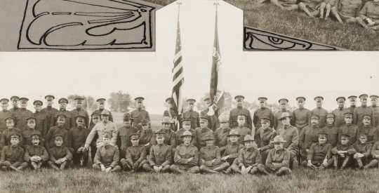 Black and white photograph of Minnesota Motor Corps officers and color guard at Camp Lakeview, Lake City, Minnesota, September, 1918. Motor Corps commander, Colonel Stephens, is kneeling left of the colors in the light colored tunic.