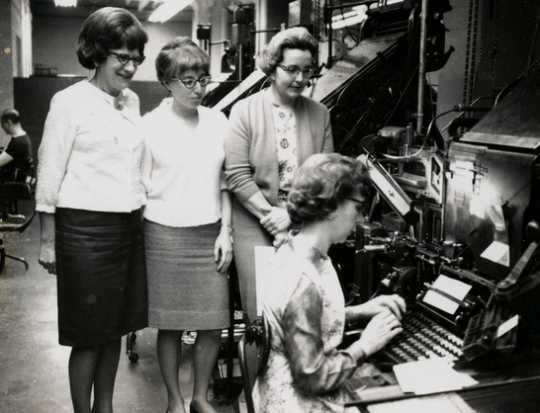 Black and white photograph of three West Publishing Company employees, c.1965. 