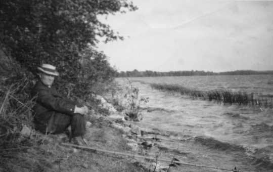 Black and white photograph of Dr. Henry Schmidt fishing, ca. 1918.
