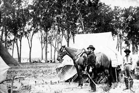 Black and white photograph of Major Brackett and his aide, Van Garren, at a camp in Dakota Territory, 1864.