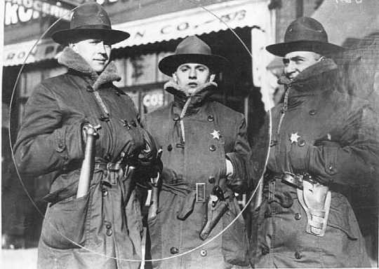 Black and white photograph of three members of the Minnesota Home Guard during the Streetcar workers strike of 1917. The stars they wear designate them as special deputy sheriffs of Ramsey County.