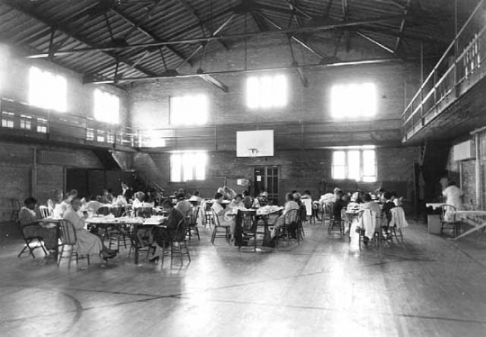 Black and white photograph of a sewing project at Phyllis Wheatley House, 1936.