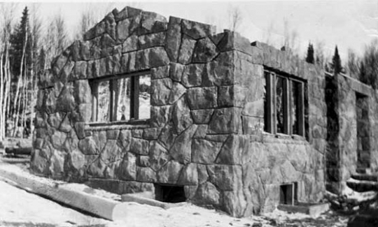 Black and white photograph of construction of a stone building by CCC Company 2710, Gooseberry Falls, ca. 1938.