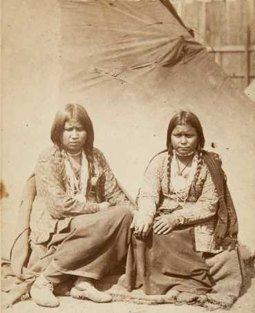 Black and white photograph of two Dakota women at the Fort Snelling concentration camp, c.1862–1863. Photograph by Joel Emmons Whitney.