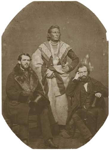 Black and white photo print of the Ho-Chunk (Winnebago) leader Baptiste Lasallier (center) with Indian Agent Charles H. Mix (right) and an Indian supply merchant from New York (left), 1857.