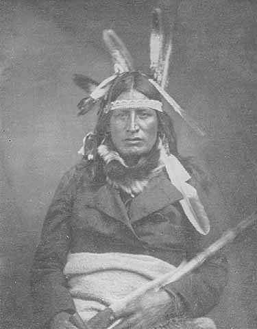 Black and white photograph of the Ho-Chunk leader Baptiste Lasallier wearing a mix of American Indian and Euro-American clothing, c.1855.