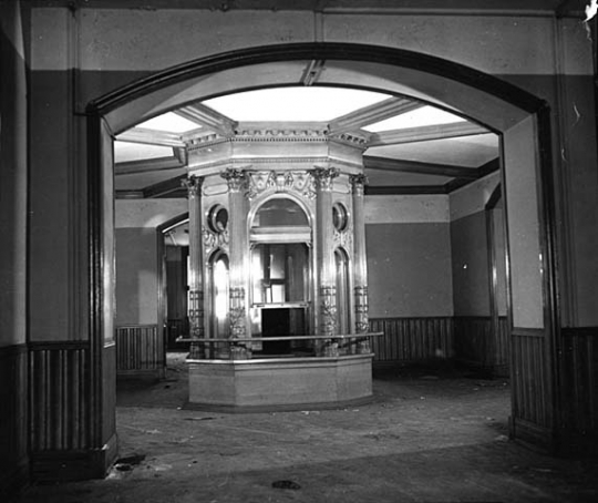 Black and white photograph of the flag case in the rotunda of the second capitol prior to demolition, 1937. Photographed by the Minneapolis Star Journal.