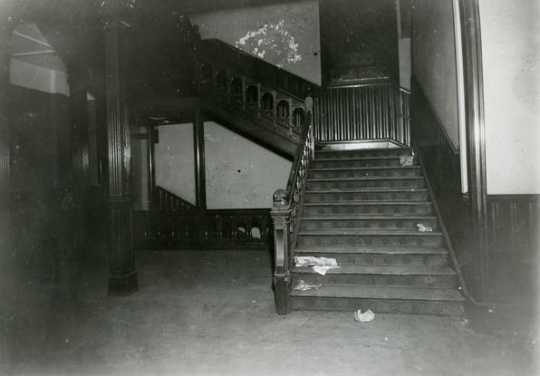 Black and white photograph of the stairway leading to the second floor of the second state capitol building prior to demolition, 1937. Photographed by A.F. Raymond.