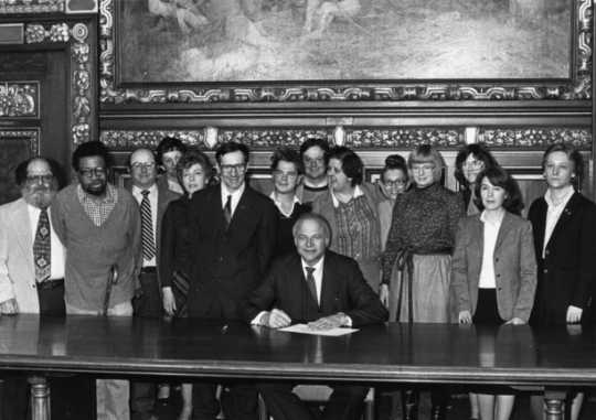 Black and white photograph of Governor Al Quie, legislators (including Allan Spear, third from left), and constituents with disabilities, ca. 1980.