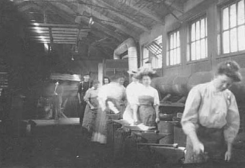 Black and white photograph of an Agriculture Extension, short course in Blacksmithing; women at the forges, 1908.