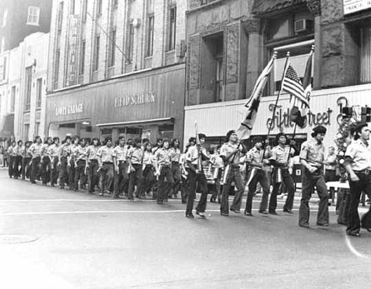 Black and white photograph of Brown Berets march in a Mexican Celebration Parade, St. Paul, September 15, 1972.