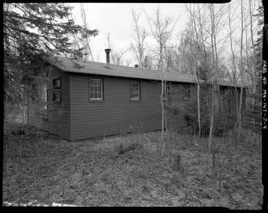 Exterior view of a barracks (Building 11), CCC Camp Rabideau F-50. Photo by Jerry Mathiason, 1994. From box 1 (144.G.8.4F) of Historic American Buildings Survey records related to Minnesota structures, 1882-2001, 1883. Manuscripts Collection, Minnesota Historical Society, St. Paul.