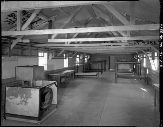 Interior view of a barracks (Building 11), CCC Camp Rabideau F-50. Photo by Jerry Mathiason, 1994. From box 1 (144.G.8.4F) of Historic American Buildings Survey records related to Minnesota structures, 1882-2001, 1883. Manuscripts Collection, Minnesota Historical Society, St. Paul.