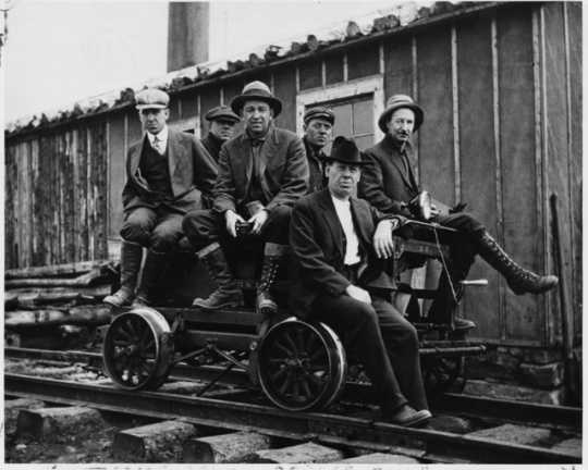 Taconite prospectors at Sulphur Camp, ca. 1916. To access Sulphur Camp, prospectors would have to take a rail cart, pictured here, from Mesaba Station. Seated to the far left is E. W. Davis.