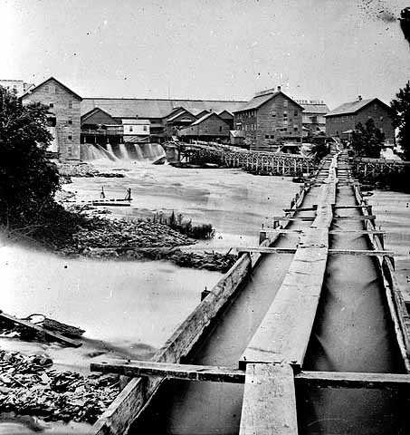 Black and white photograph of a cluster of Minneapolis sawmills, c.1865.