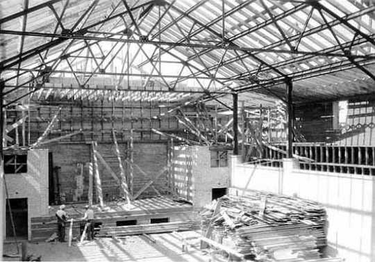 Black and white photograph of Deerwood Auditorium interior under construction, c. 1936.