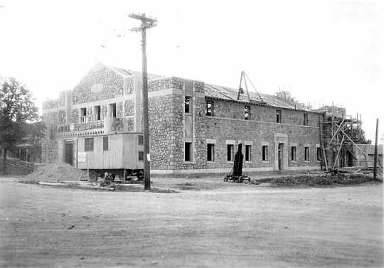 Black and white photograph of the exterior of Deerwood Auditorium exterior under construction, c.1936.