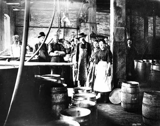 Black and white photograph of M. A. Gedney Compnay workers and vinegar barrels, c.1912.