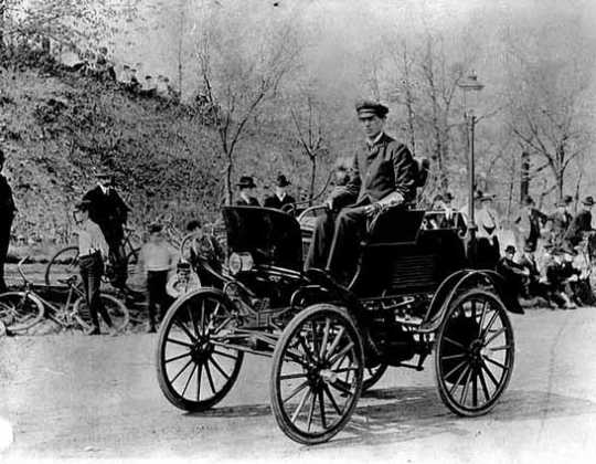 Black and white photograph of Swan Turnblad, ca. 1900 driving his Waverly automobile—the first commercially available car owned by a Minnesotan.