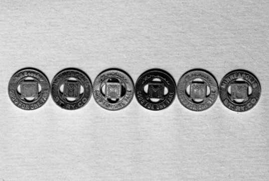 Black and white photograph of Minneapolis Street Railway streetcar tokens, 1947.