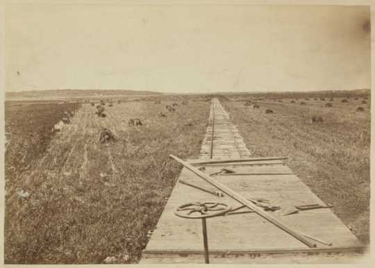 Sepia-tone photograph of railroad construction taken by Benjamin Franklin Upton, c.1868.