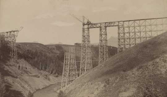 Black and white photograph of the Great Northern Railway trestle over Two Medicine in course of construction, ca. 1877. 