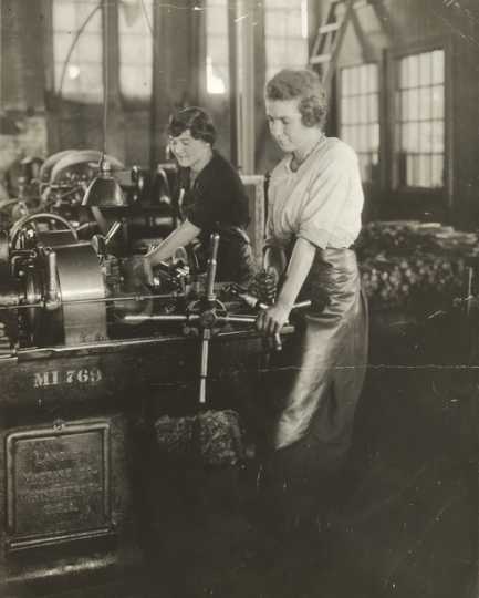 Black and white photograph of women handling lath machines in Northern Pacific Railway's Como Shops, ca. 1920.