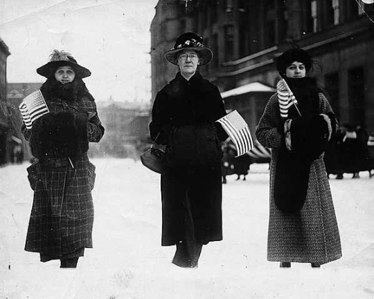 Black and white photograph of women marching with American flags, Street Railway Company strike, 1917.