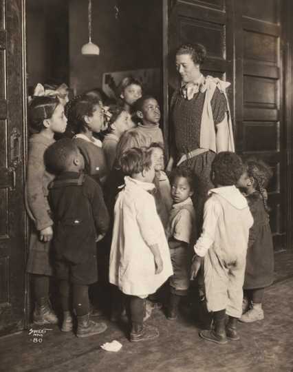 Black and white photograph of Gertrude Brown with children at Phyllis Wheatley House, ca. 1924.