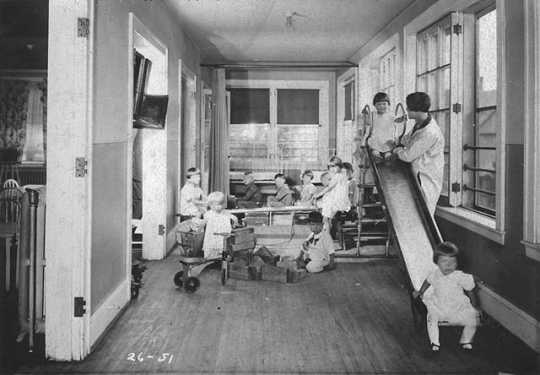 Black and white photograph of children playing at the Neighborhood House, c.1925.