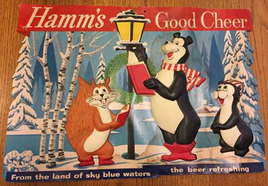 Photograph of “Hamm’s Good Cheer” holiday promotional sign featuring the Hamm’s bear, little bear, and squirrel, mid-to-late 1950s.