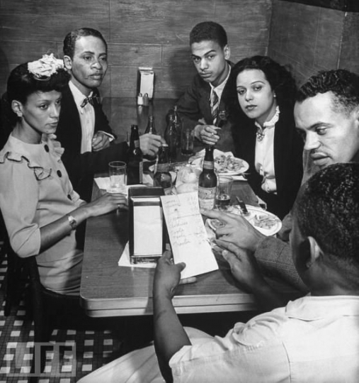 Black and white photograph of Hilda Simms with Earl Hollman and other actors from the Harlem Theater in New York City, c.1943.