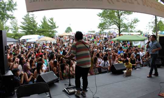 Color image of Hmong recording artists Kong and Shu perform at the 11th Annual Hmong Arts & Music Festival at Como Park in St. Paul, July, 2014. 