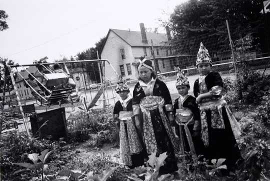 Black and white photograph of Hmong women in traditional costume, Frogtown, 1993. Photograph by Wing Young Huie.