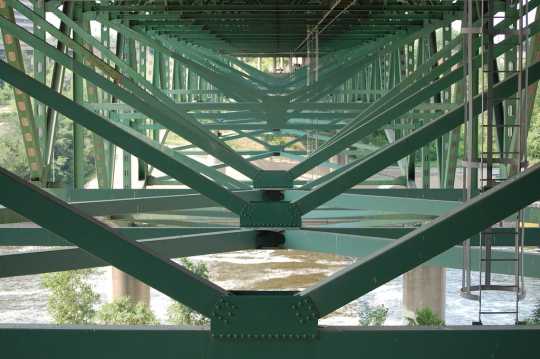 Underside of the bridge showing the deck truss construction and gusset plates. Photo by Flickr user ibran. BY-NC-ND 2.0