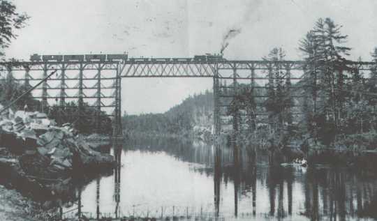 High bridge over the Kettle River near Sandstone before September 1, 1894, and before the trees in the area were cut down by a logging company, which left highly flammable debris (slash) to serve as fire fuel. Photograph Collection, Hinckley Fire Museum, Hinckley.