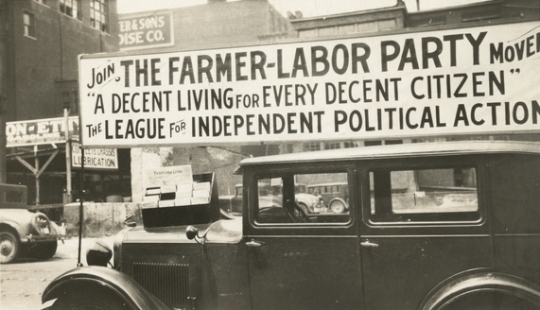 Black and white photograph of a Farmer-Labor political poster atop an automobile, c.1925.