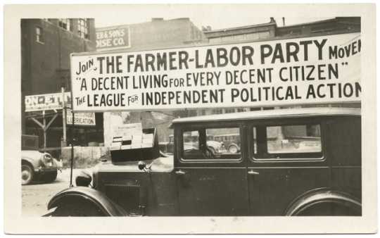 A Farmer-Labor political poster atop an automobile, ca. 1925.