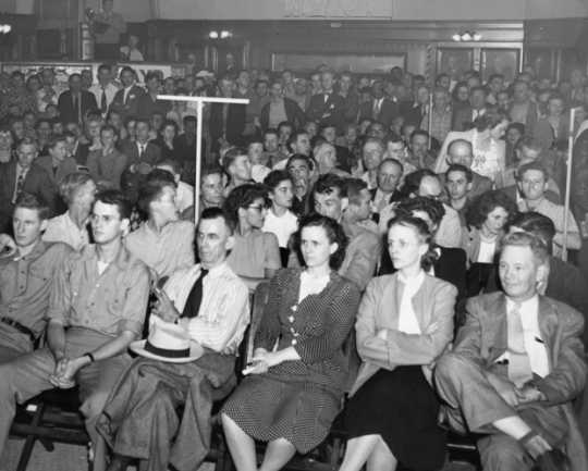 Black and white photograph of a Socialist Workers Party meeting, ca. 1940. Vincent R. Dunne and Grace Carlson in center.